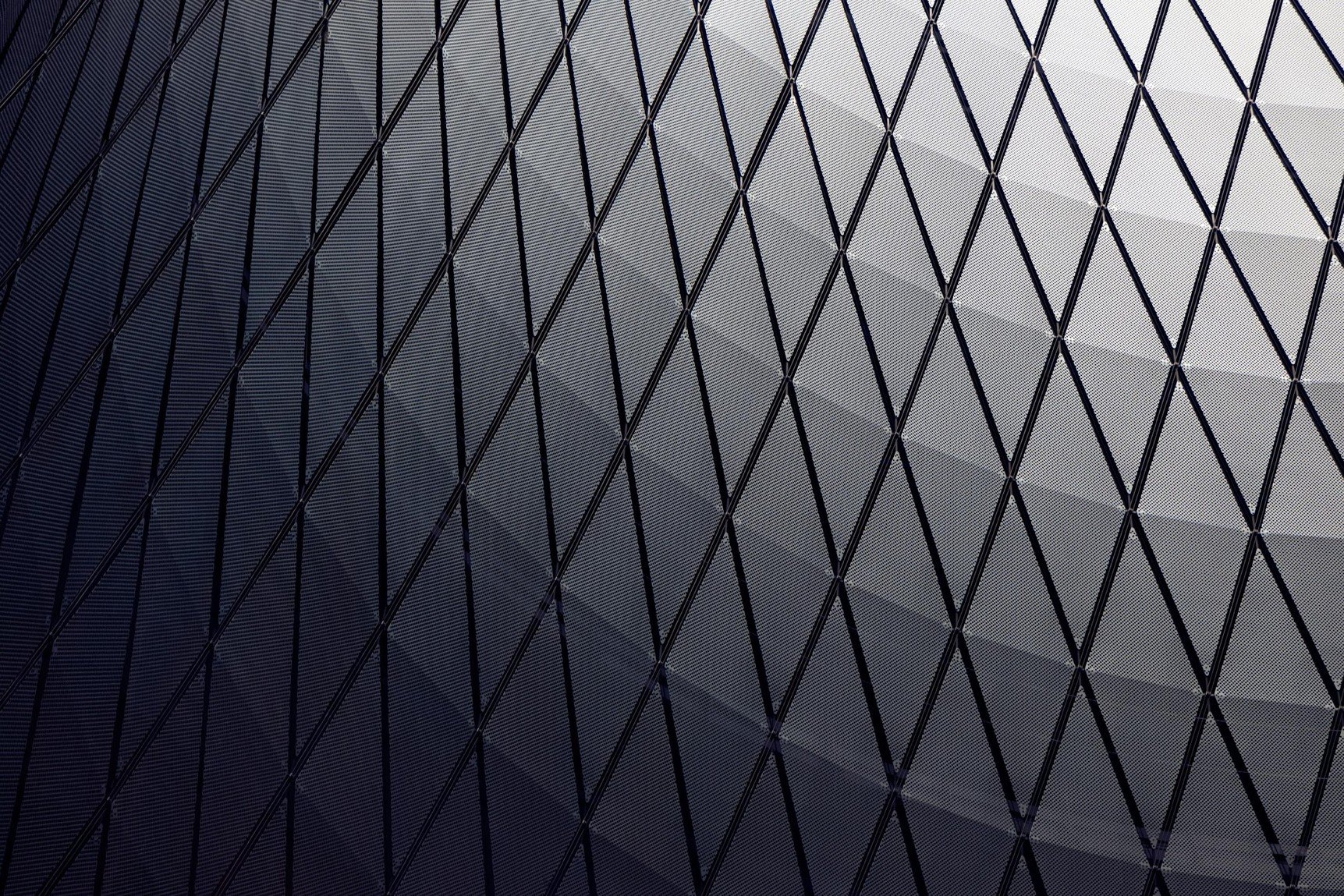 A sweeping architectural façade with a precise, repeating diamond structure